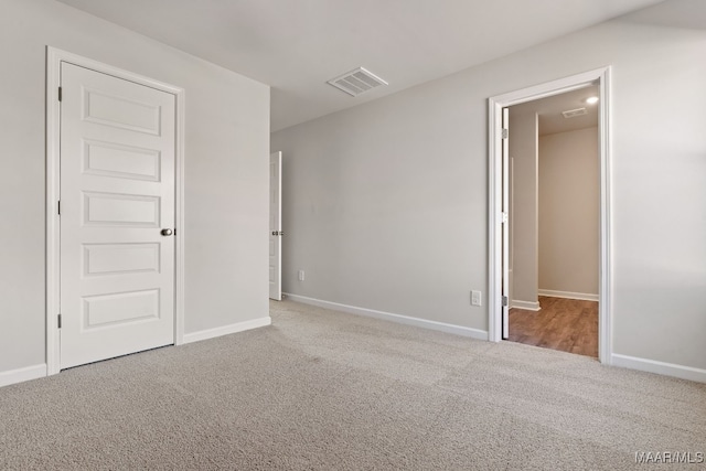 unfurnished bedroom featuring light carpet