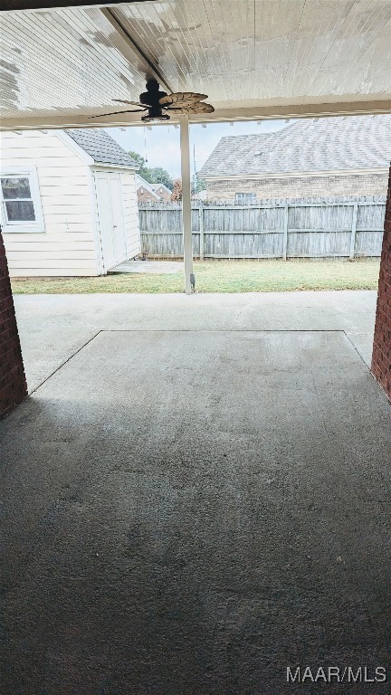 view of patio featuring ceiling fan and a storage shed