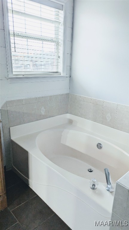 bathroom featuring tile patterned flooring and a bathtub