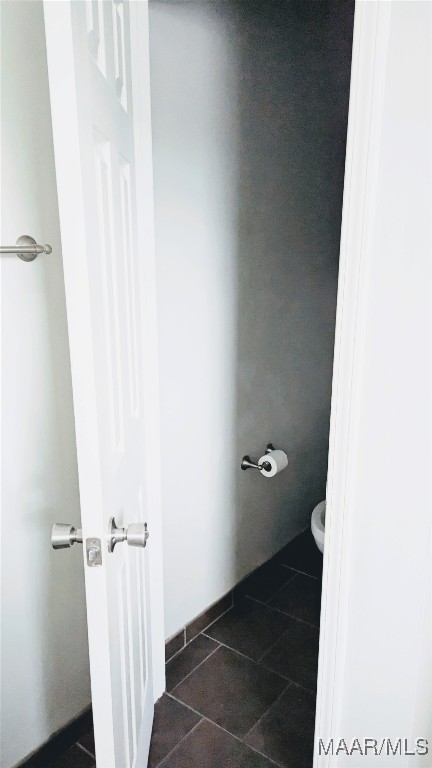 bathroom with tile patterned floors and toilet