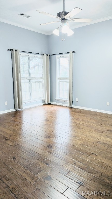 empty room featuring ceiling fan, hardwood / wood-style floors, and ornamental molding