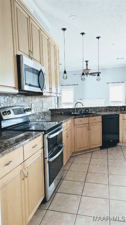 kitchen featuring backsplash, stainless steel appliances, sink, pendant lighting, and light tile patterned flooring