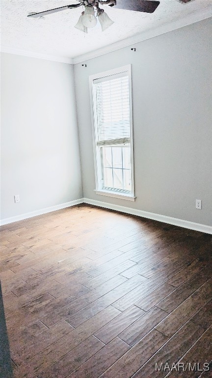 unfurnished room with crown molding, ceiling fan, dark wood-type flooring, and a textured ceiling