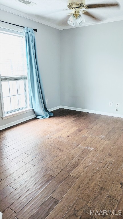 spare room with crown molding, hardwood / wood-style floors, and ceiling fan