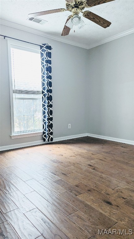 spare room with hardwood / wood-style floors, ceiling fan, ornamental molding, and a textured ceiling