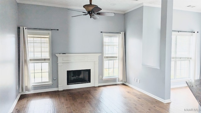 unfurnished living room with plenty of natural light, wood-type flooring, and a brick fireplace