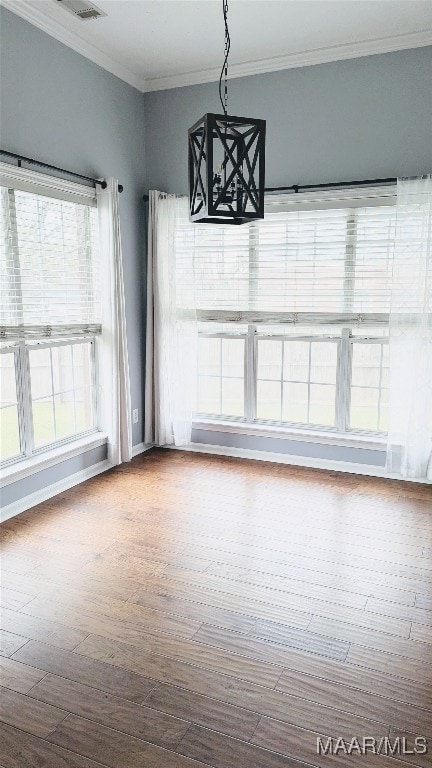 unfurnished dining area with wood-type flooring and ornamental molding