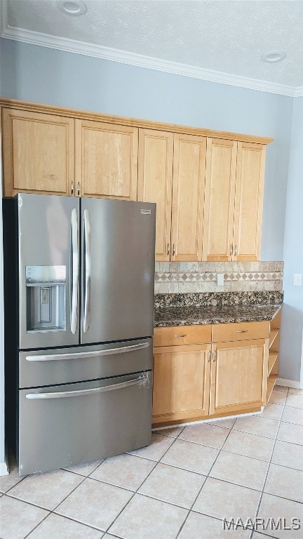 kitchen with stainless steel refrigerator with ice dispenser, decorative backsplash, ornamental molding, light tile patterned floors, and light brown cabinetry