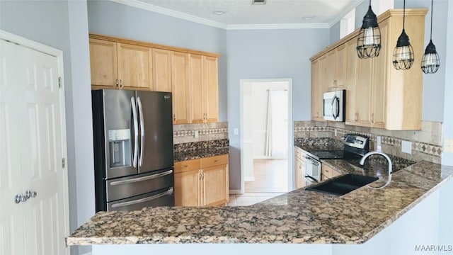 kitchen featuring sink, stainless steel appliances, backsplash, kitchen peninsula, and dark stone countertops