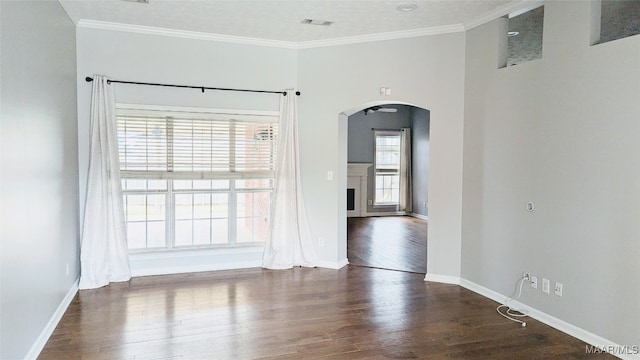 unfurnished room with ornamental molding and dark wood-type flooring