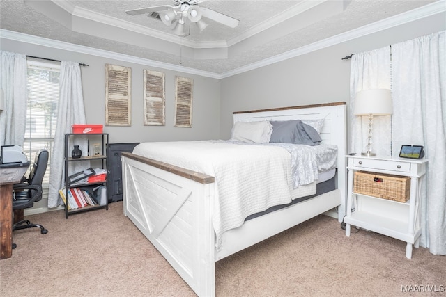 carpeted bedroom featuring ceiling fan, a raised ceiling, and crown molding