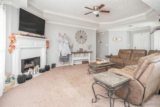 living room with carpet floors, crown molding, ceiling fan, and a textured ceiling