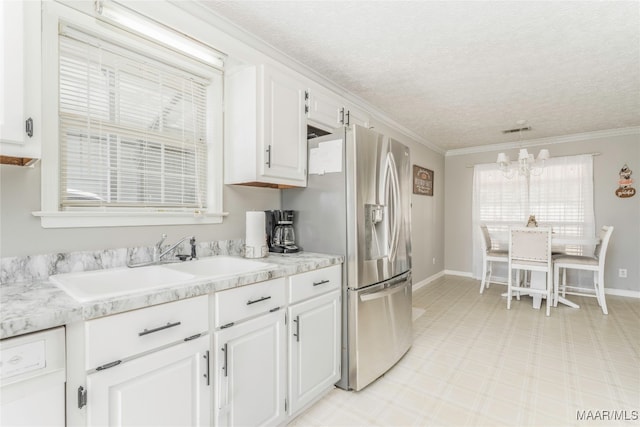 kitchen with white cabinets, decorative light fixtures, ornamental molding, and sink