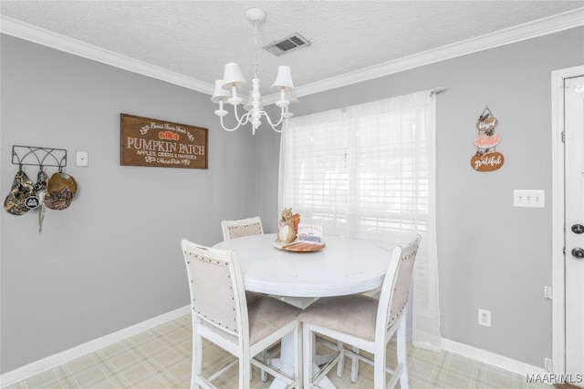 dining area featuring crown molding, a textured ceiling, and an inviting chandelier