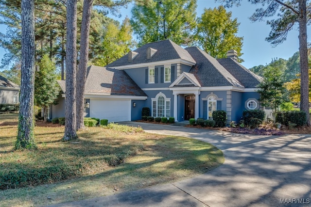 view of front of home featuring a front lawn and a garage