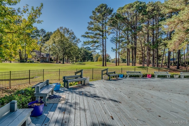 wooden terrace with a lawn