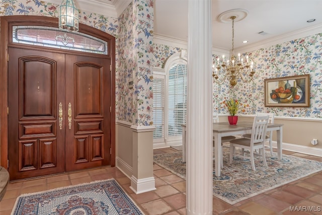 foyer with crown molding and an inviting chandelier