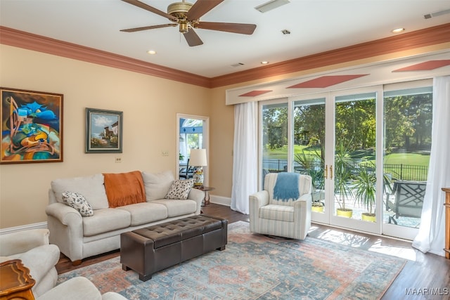 living room with crown molding, ceiling fan, and wood-type flooring