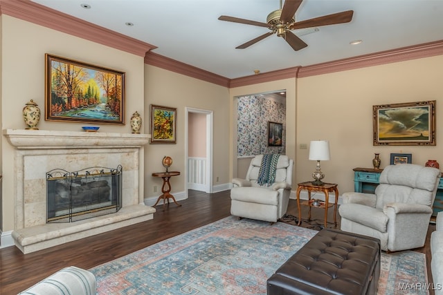 living room featuring a fireplace, dark hardwood / wood-style floors, ceiling fan, and ornamental molding