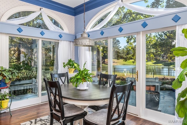 sunroom / solarium with a water view