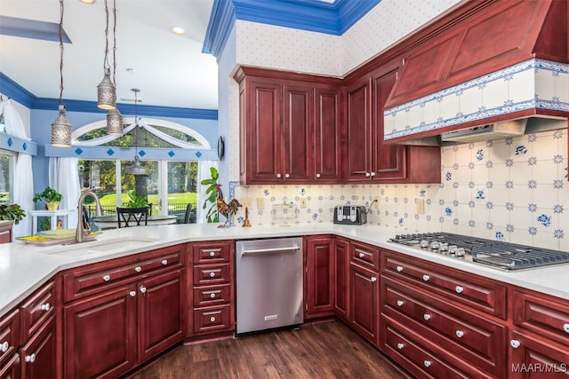 kitchen featuring sink, crown molding, hanging light fixtures, dark hardwood / wood-style floors, and appliances with stainless steel finishes