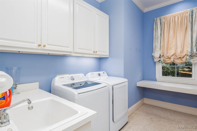 washroom featuring washer and clothes dryer, cabinets, light carpet, sink, and crown molding