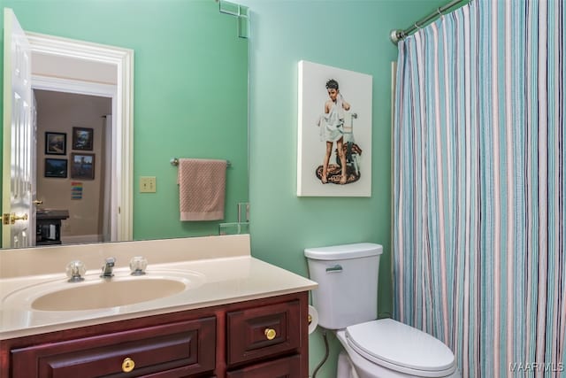 bathroom featuring vanity, a shower with shower curtain, and toilet