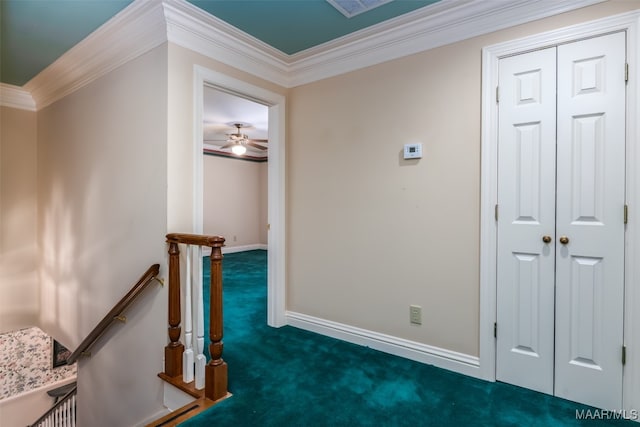 corridor featuring crown molding and dark colored carpet