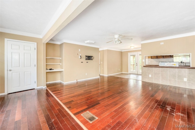 unfurnished living room featuring hardwood / wood-style floors, built in features, ceiling fan, and ornamental molding