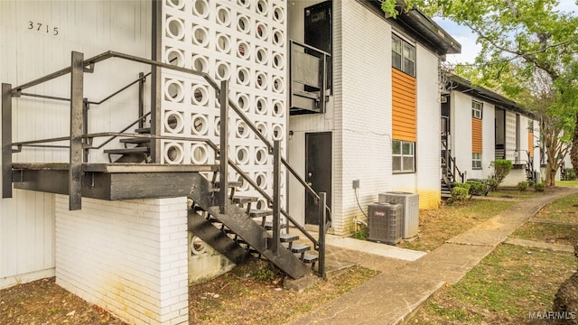 view of side of property with central air condition unit