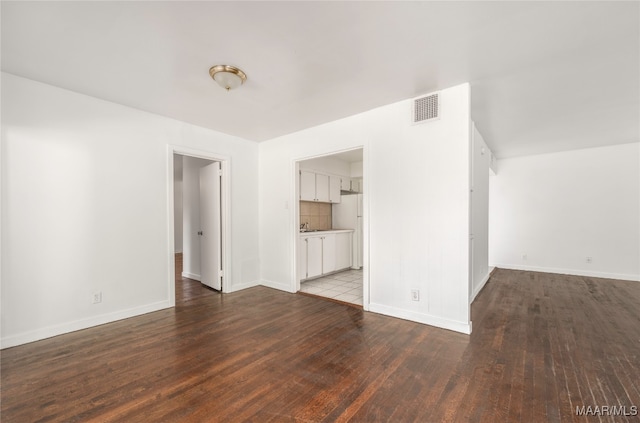 unfurnished living room featuring wood-type flooring