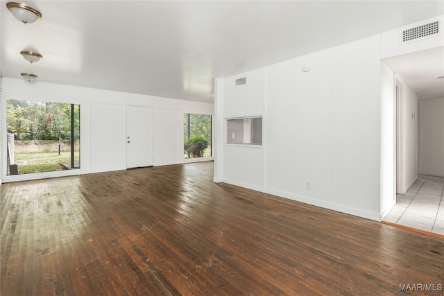 unfurnished living room featuring dark wood-type flooring