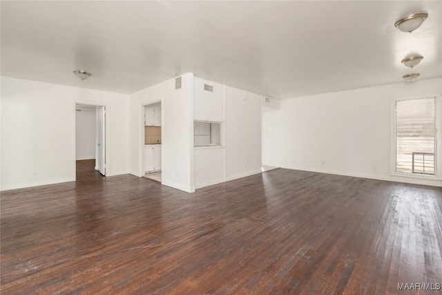 unfurnished living room with dark wood-type flooring