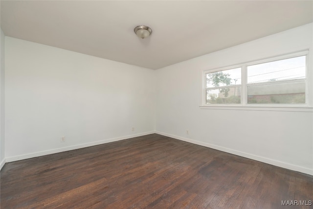 spare room featuring dark hardwood / wood-style flooring