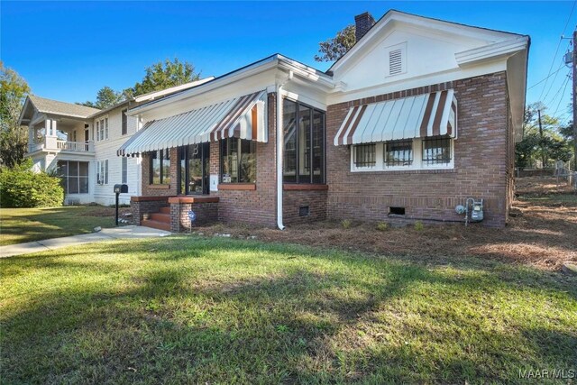 1427 S Court St, Montgomery, AL 36104 - view of front of home featuring crawl space, a front lawn, brick siding, and a chimney