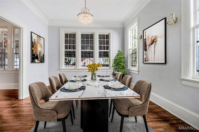 dining room with dark hardwood / wood-style floors, crown molding, and an inviting chandelier