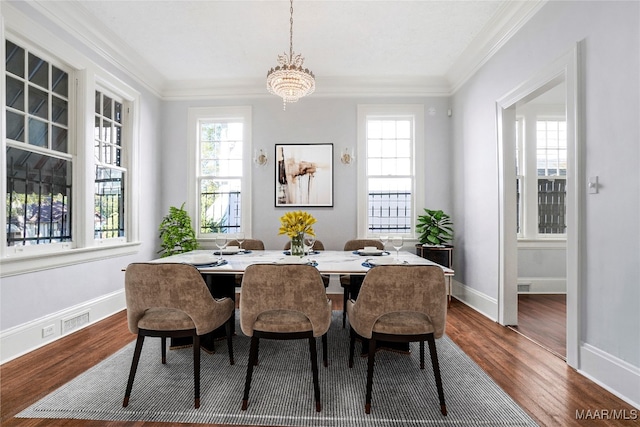 dining space with a chandelier, dark hardwood / wood-style floors, and ornamental molding