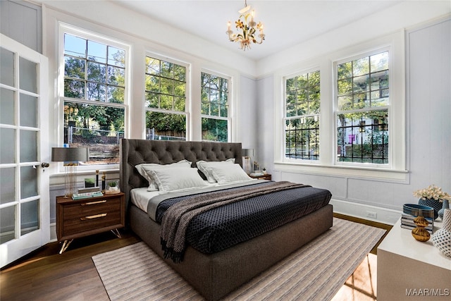 bedroom featuring dark hardwood / wood-style flooring and a chandelier