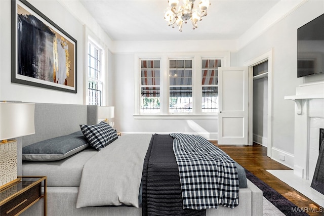 bedroom featuring dark hardwood / wood-style floors and a chandelier