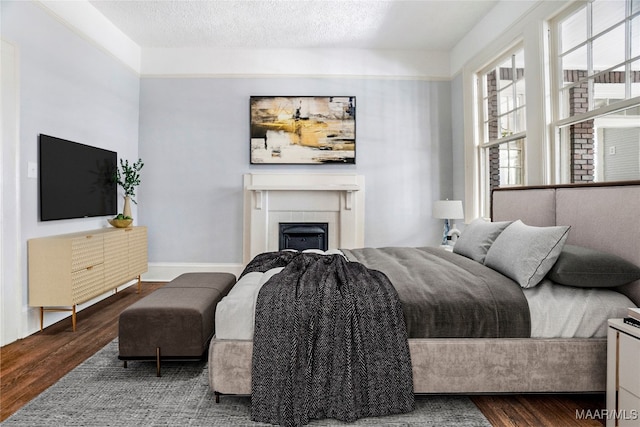 bedroom with wood-type flooring and a textured ceiling