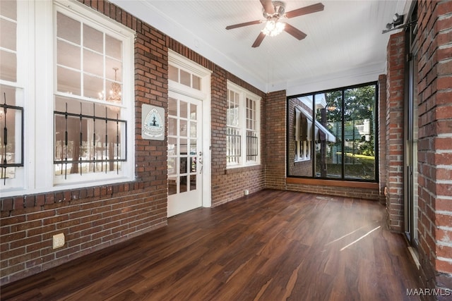 unfurnished sunroom with ceiling fan