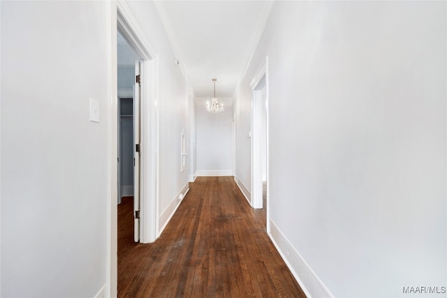 hallway featuring a chandelier and dark hardwood / wood-style floors