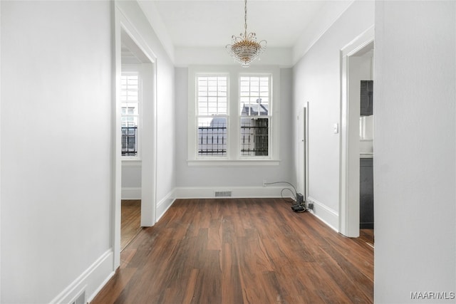 interior space featuring dark hardwood / wood-style flooring and a chandelier