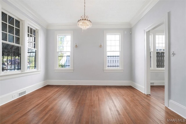 1427 S Court St, Montgomery, AL 36104 - unfurnished dining area featuring wood finished floors, a chandelier, ornamental molding, and baseboards