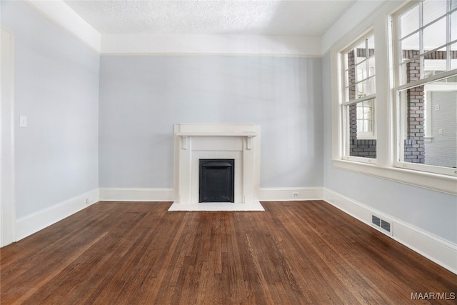 unfurnished living room with a textured ceiling and hardwood / wood-style flooring