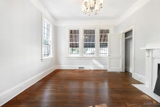 1427 S Court St, Montgomery, AL 36104 - unfurnished dining area with a chandelier, healthy amount of natural light, a fireplace with flush hearth, and wood finished floors