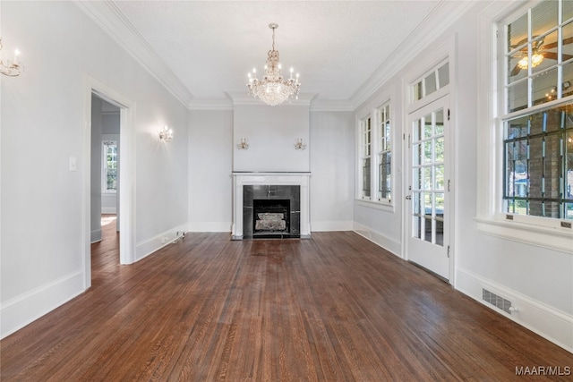 unfurnished living room with a chandelier, a fireplace, dark wood-type flooring, and ornamental molding