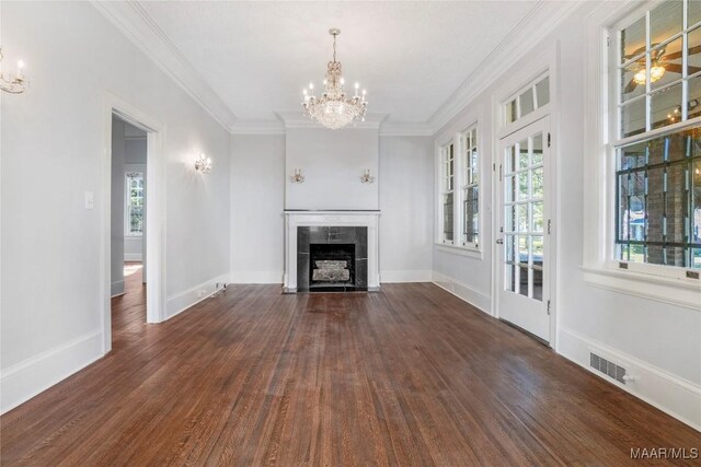 1427 S Court St, Montgomery, AL 36104 - unfurnished living room featuring a chandelier, plenty of natural light, wood finished floors, and crown molding