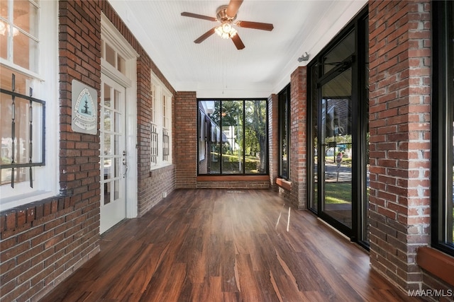 unfurnished sunroom with ceiling fan and a wealth of natural light