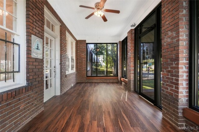 1427 S Court St, Montgomery, AL 36104 - unfurnished sunroom featuring brick wall, wood finished floors, and a ceiling fan